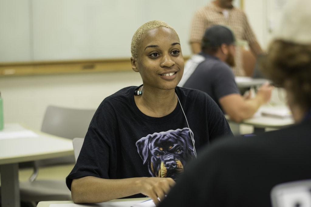 A Plant Sciences student energetically talks in class. 