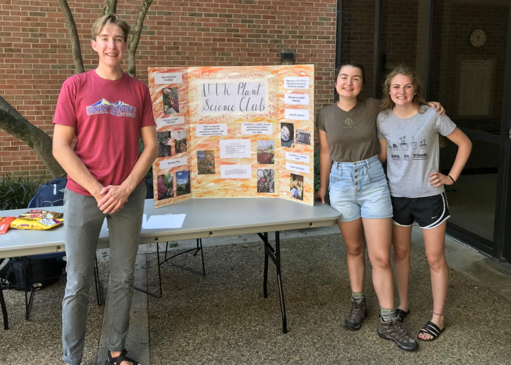 UT Plant Science Club members pose with their display at a UT Herbert event. 