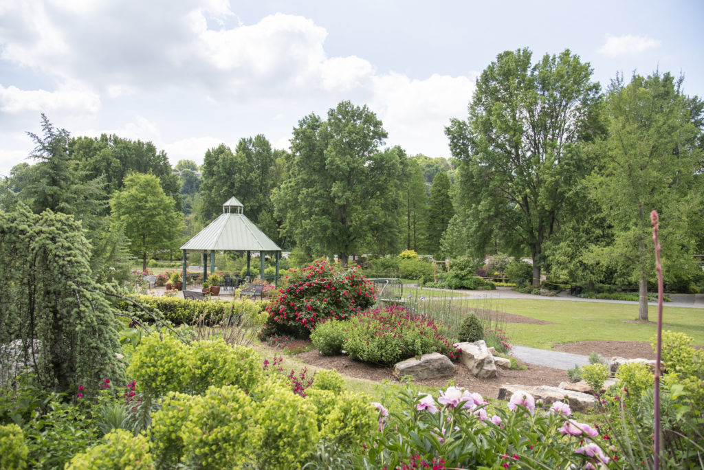 A view of a gazebo amongst UT Gardens in bloom on a clear Spring day