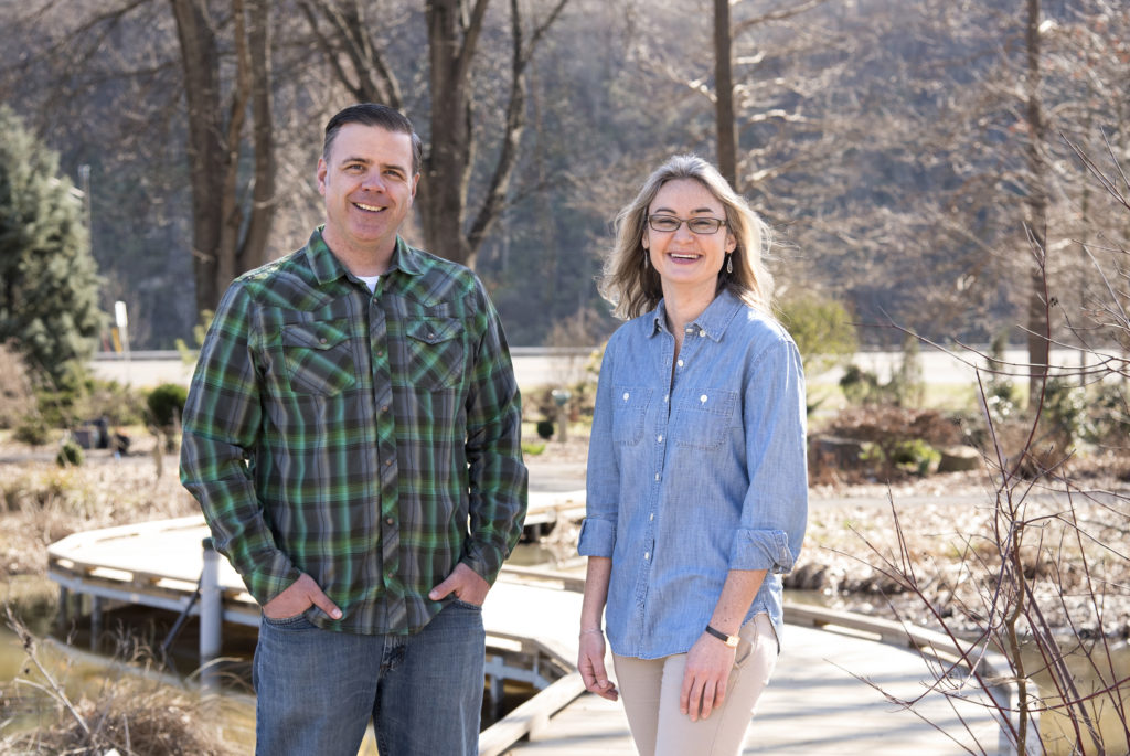 Andrew Pulte and Natalie Bumgarner are photographed standing on the UT Gardens wetlands bridge on a sunny day