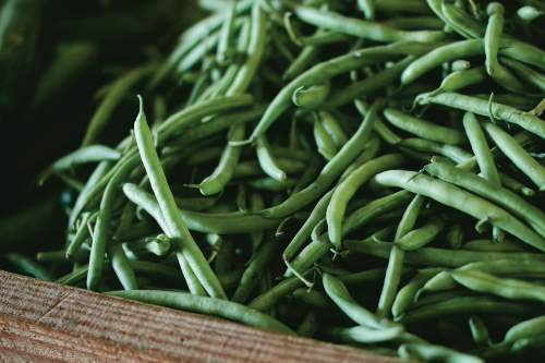 A wooden box full of Green beans 