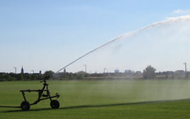 Large automatic Watering device spraying a field