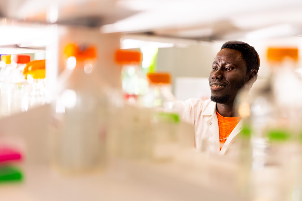 Student seen through a lab shelf