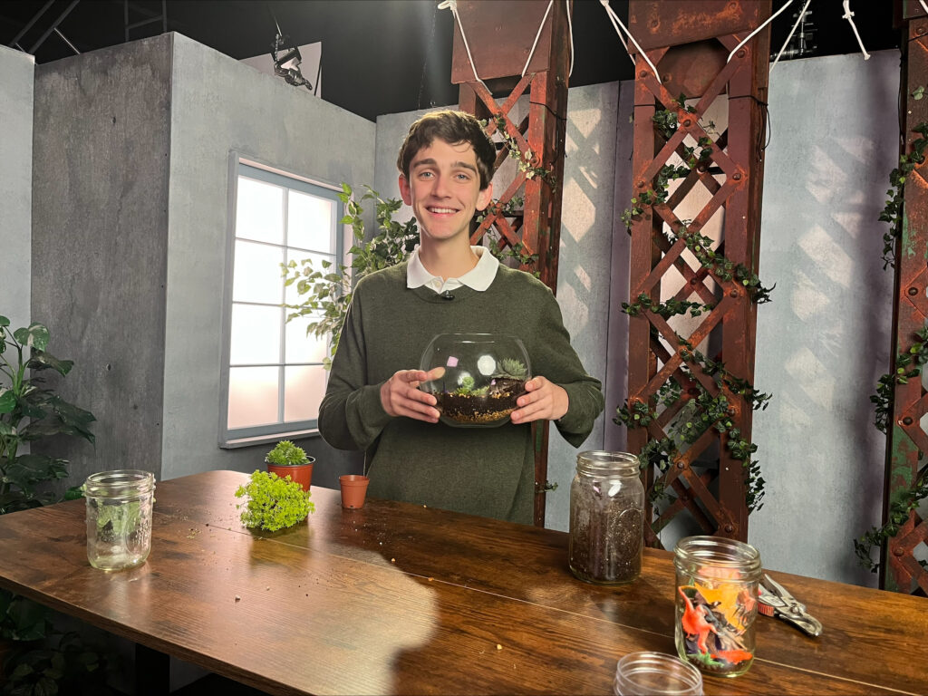 Student holding a terrarium