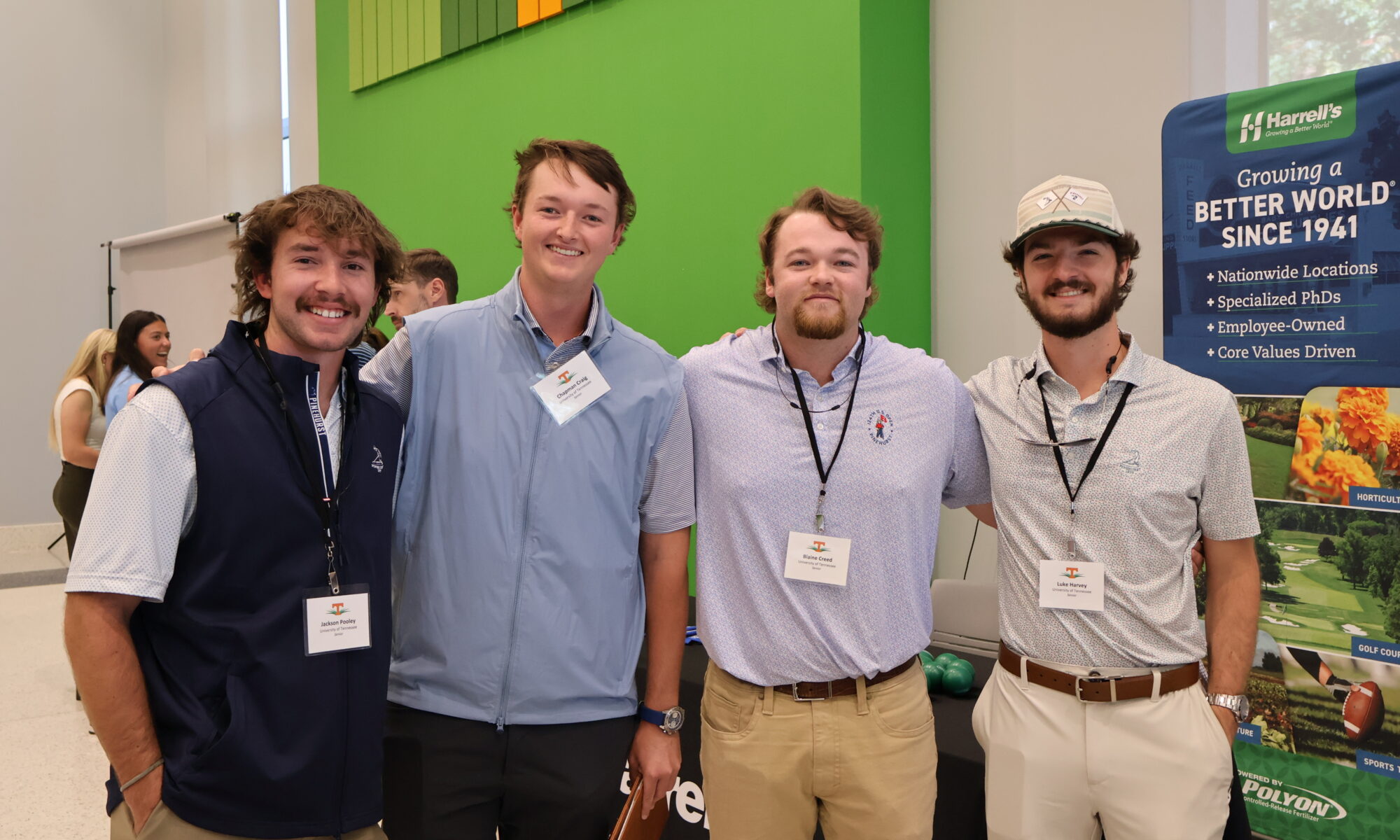 Four men smiling looking at the camera