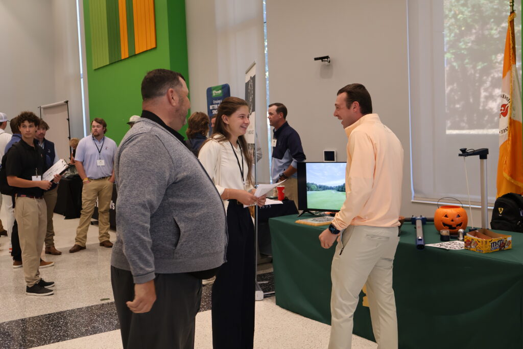 There people laughing and smiling at a career fair