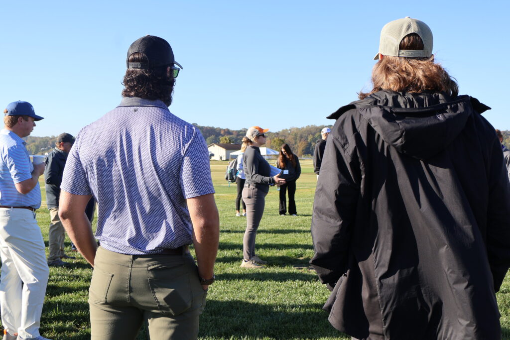 Woman presenting to a group of people outside