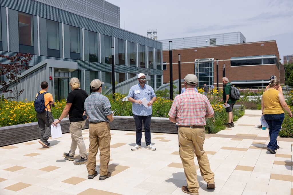 Man showcasing a green roof to people