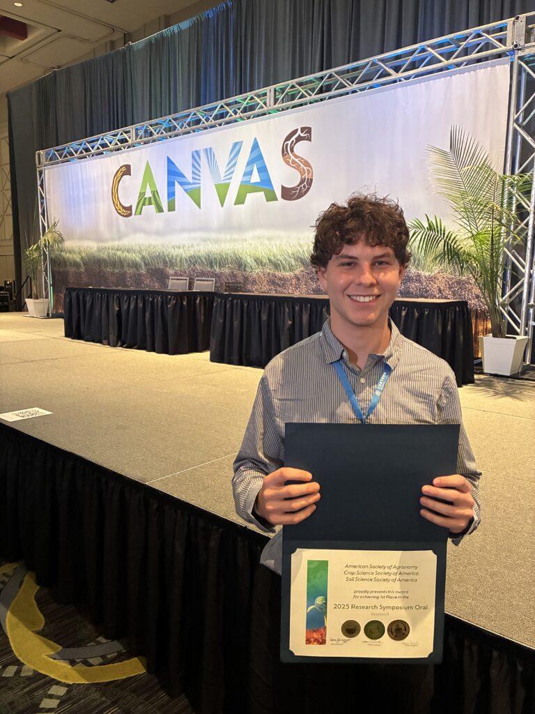 Photo of a man holding up an award