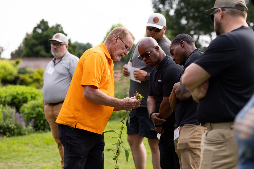 Man showing people a flower