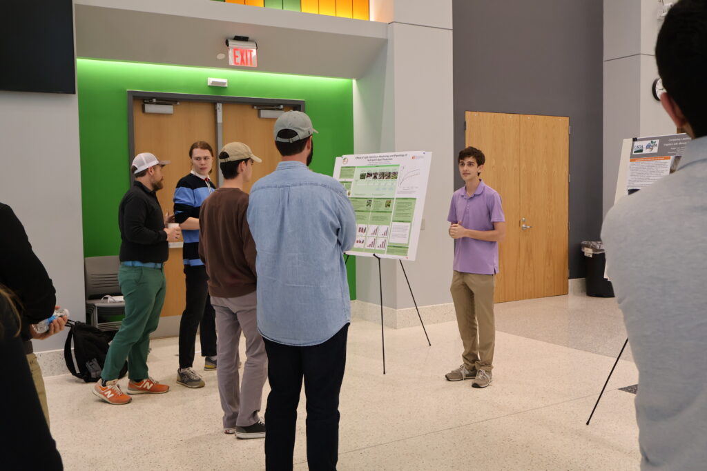 People watching someone present a poster