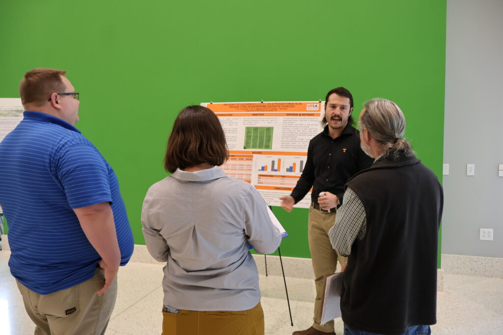 People watching someone present a poster