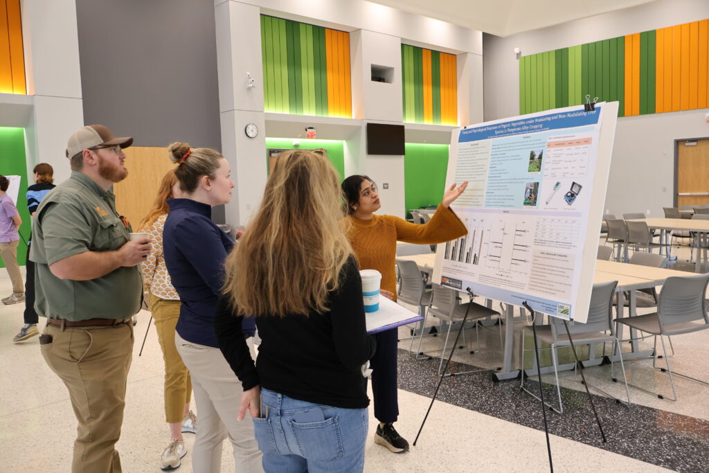 People watching someone poresent a poster