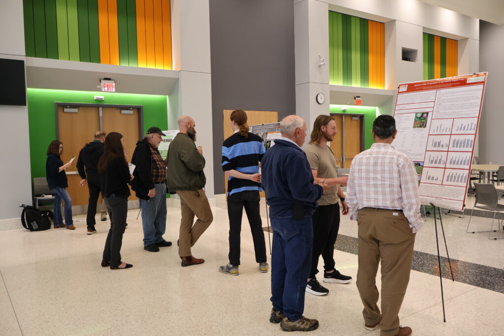 Wide shot of people looking at posters