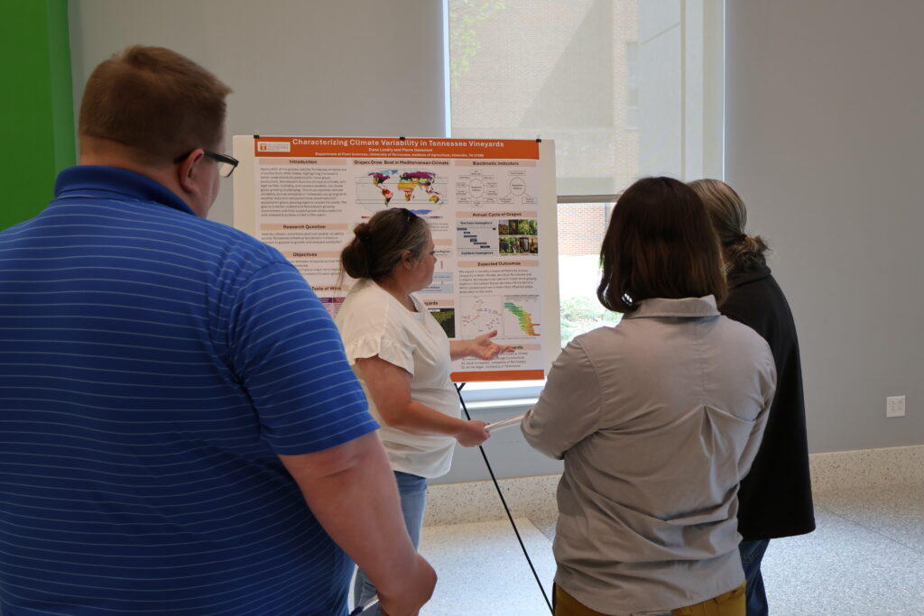 People watching someone present a poster