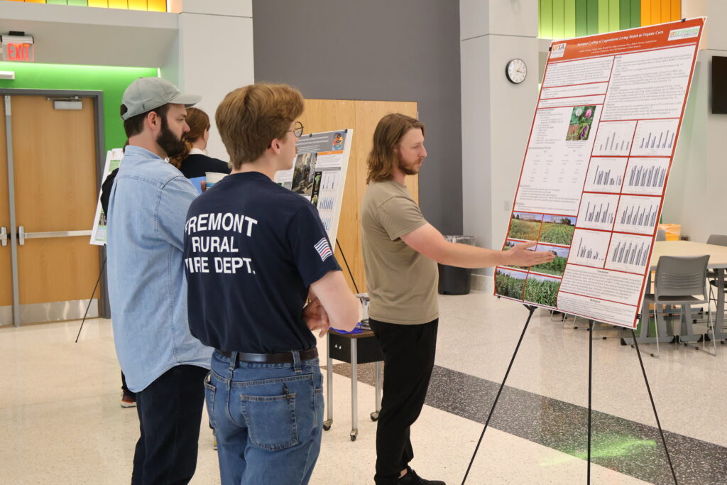 People watching someone present a poster