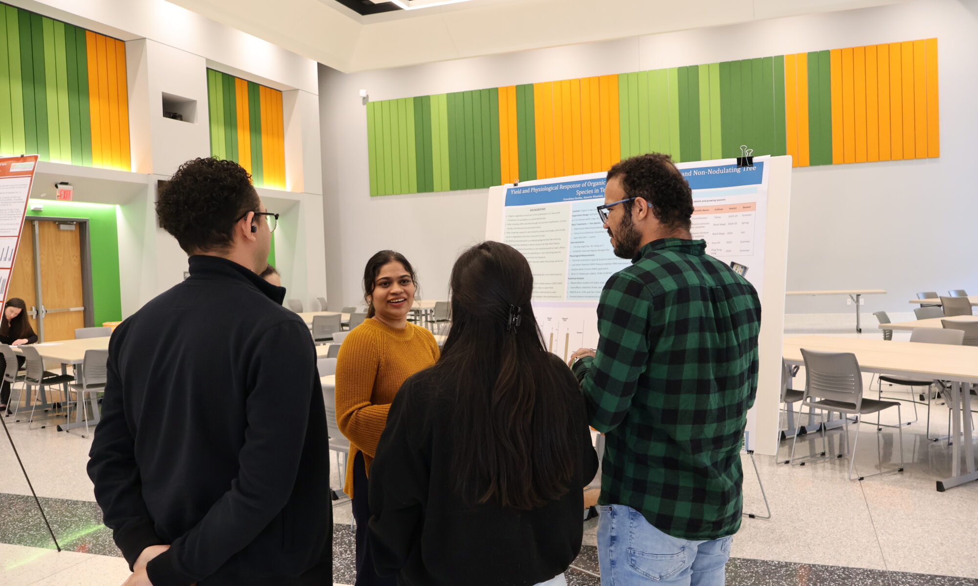 People gathered around a poster and presenter
