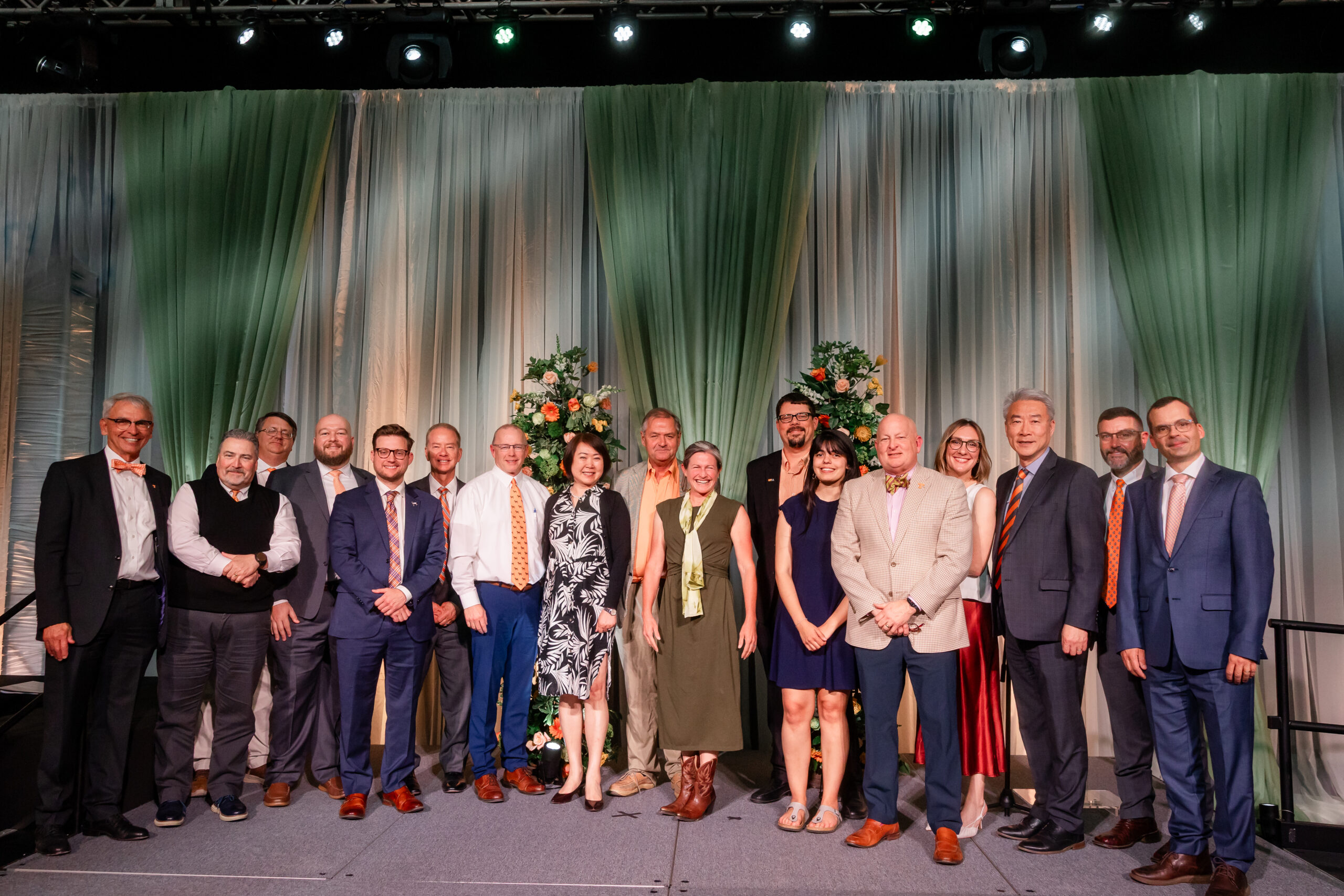Group of people on a stage smiling